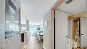 A modern interior with a kitchen, dining area, and a bathroom with a shower and toilet.