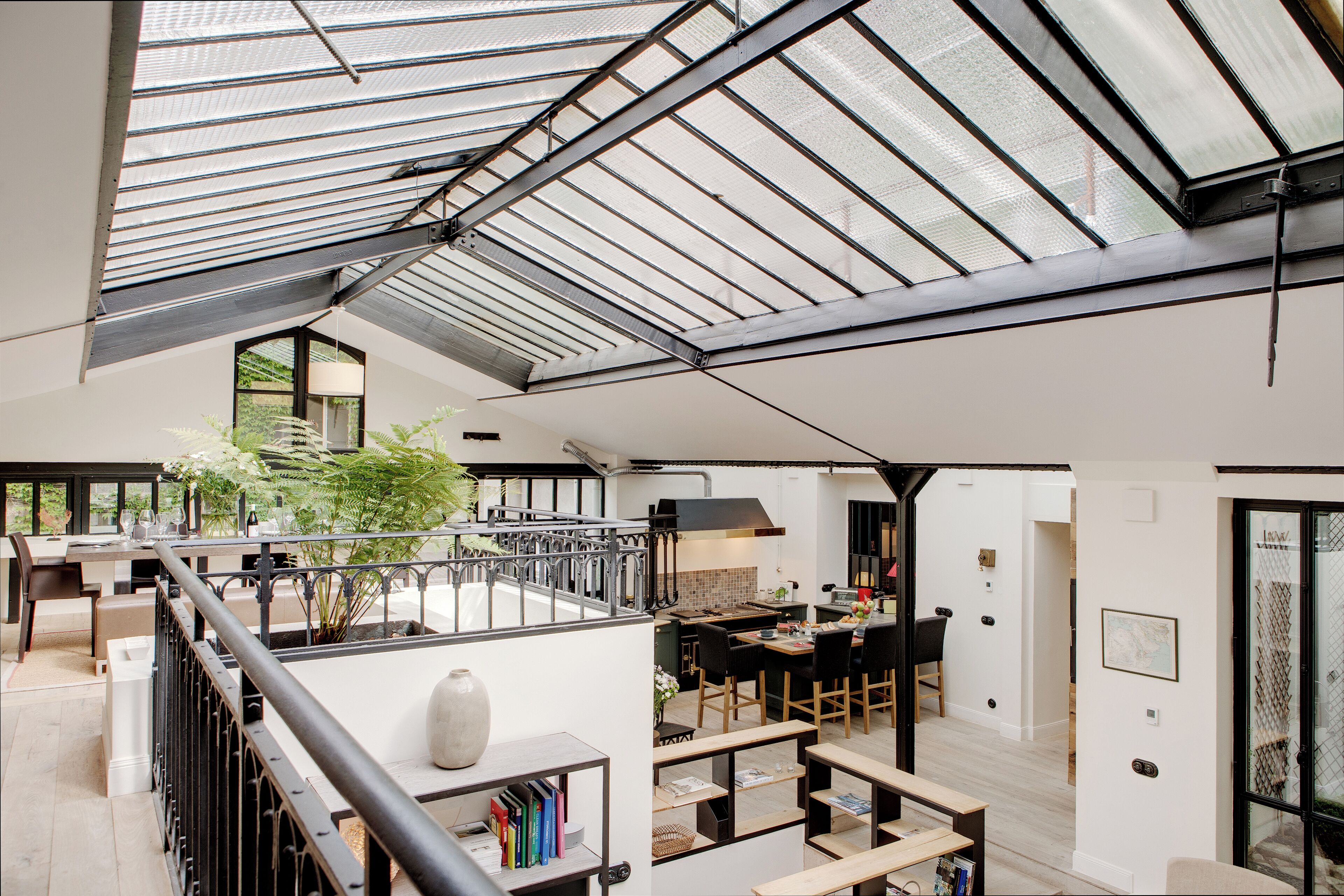 A spacious interior with a high ceiling, a dining area, and a kitchen.
