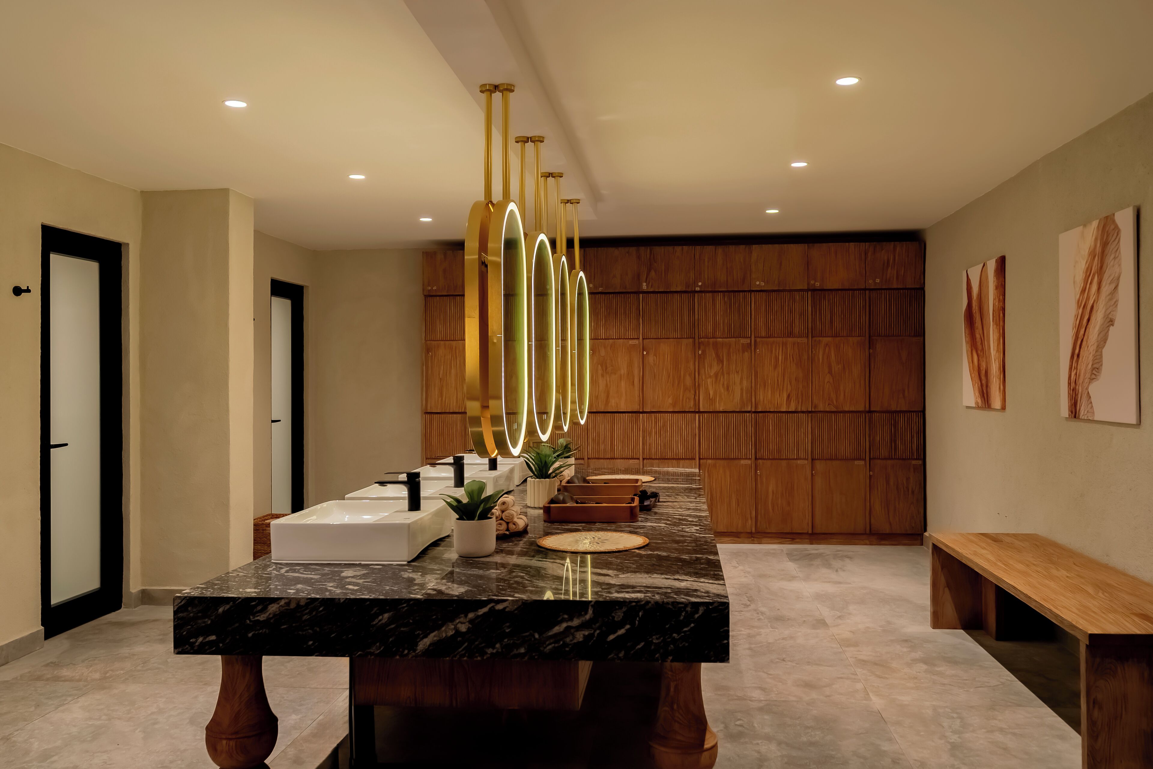 A modern bathroom with a marble countertop, a white sink, and a wooden vanity.
