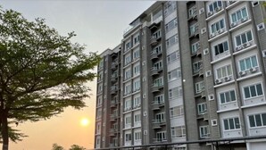 A multi-story residential building with balconies, a gated entrance, and a clear sky. - Hotel O Bayu Service Apartment (Langkawi)
