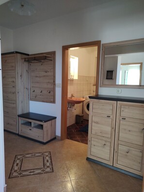 A compact kitchen with wooden cabinets, a countertop, and a sink. - Apartment Lemi - three bedroom apartment with a sea view (Ražanac)