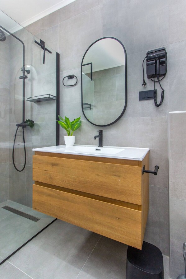 Shower, hair dryer, towels, toilet paper