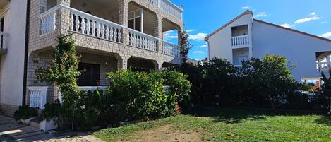 A two-story building with a balcony on the second floor.