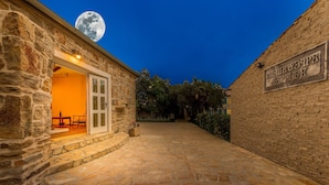 A stone building with a moon in the sky, a sign on the wall, and a stone pathway. - Villa Lemon ZadarVillas (Vir)