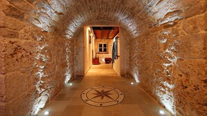 A stone-walled corridor with a tiled floor and a compass design. - Villa Lemon ZadarVillas (Vir)