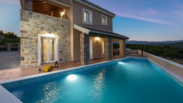 A modern house with a swimming pool, stone exterior, and a view of the mountains. - Villa Imperia ZadarVillas (Pridraga)
