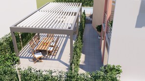 Relax on the rooftop terrace with a pergola, surrounded by lush greenery and a seating area with a bench.