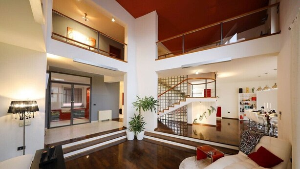 A spacious, multi-level living area with a staircase, a dining area, and a seating area with a sofa and a coffee table. - Villa Amarena ZadarVillas (Zadar)