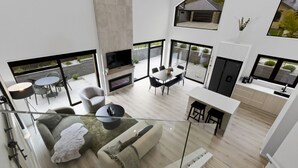 A modern open-plan living area with a fireplace, dining table, and seating. - Marvellous on Muster - family home, mountain views (Jacks Point)