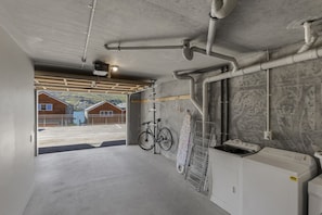 Convenient laundry facilities offer a washing machine and space to hang clothes.