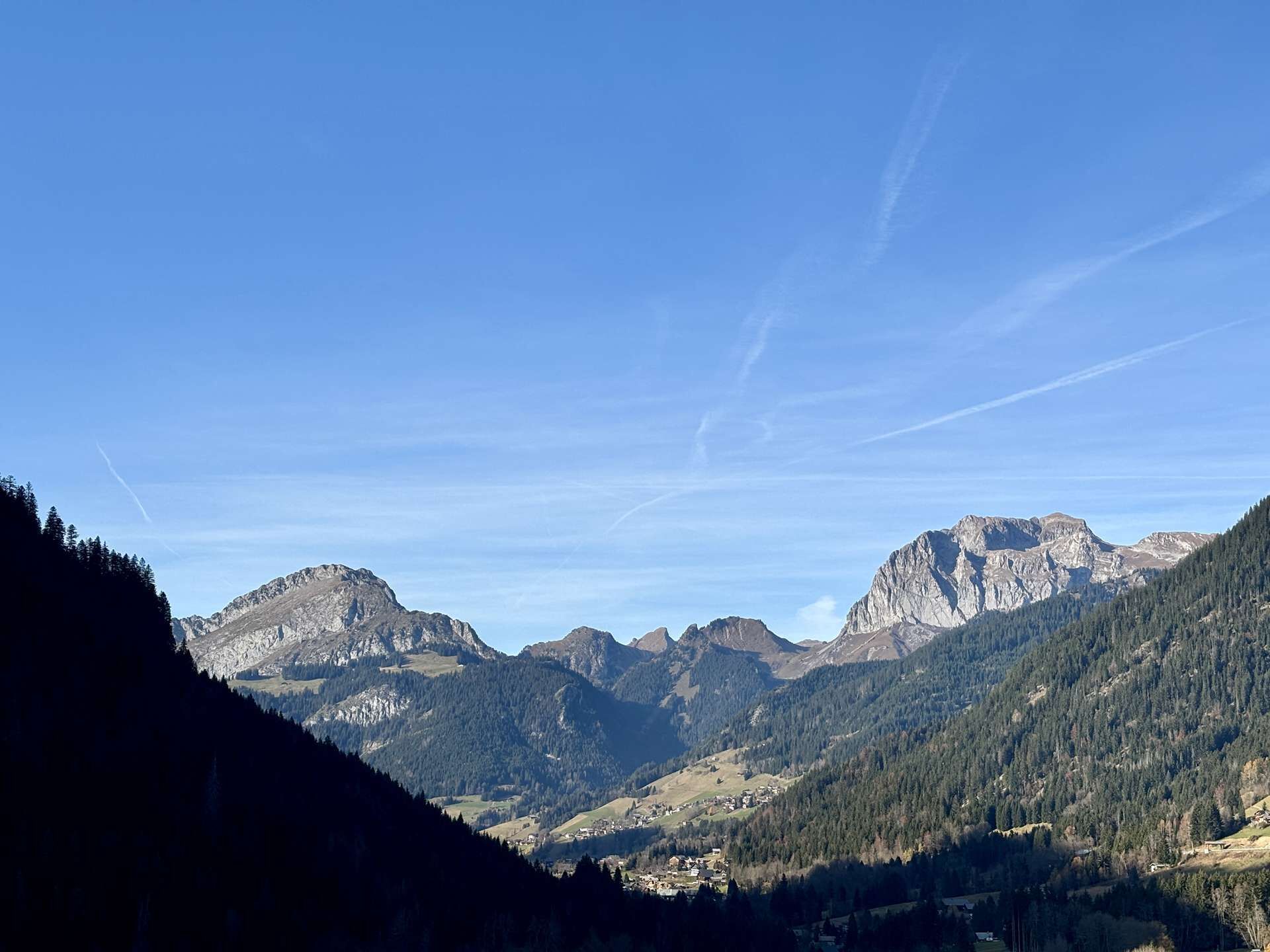 A mountainous landscape with clear skies and distant peaks.