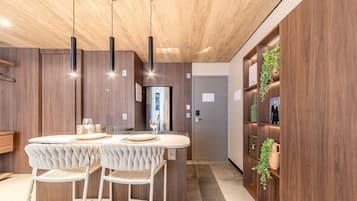 A modern kitchen with a central island, pendant lighting, and a built-in wine rack.