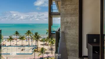 A modern building with a view of a beach and ocean.