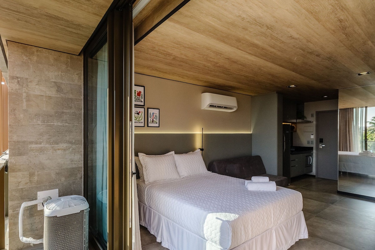 Une chambre à coucher moderne avec un grand lit, un ventilateur de plafond et une fenêtre.