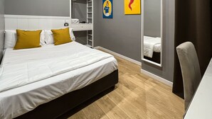 A modern bedroom with a large bed, a wardrobe, a desk, and a mirror. - Tiè tiè (Naples)