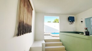 A staircase leading to a pool area with a view of greenery outside. - Vilab  (Porto Seguro)