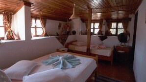 A rustic cabin with wooden ceilings and walls, two beds with white linens, and a large window with curtains. - Vome (Ortaca)