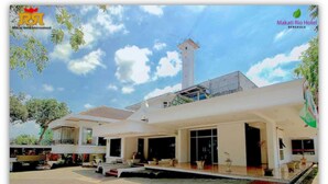 A modern hotel with a prominent tower, spacious outdoor area, and a well-maintained garden. - Makati Rio Hotel (Bengkulu)
