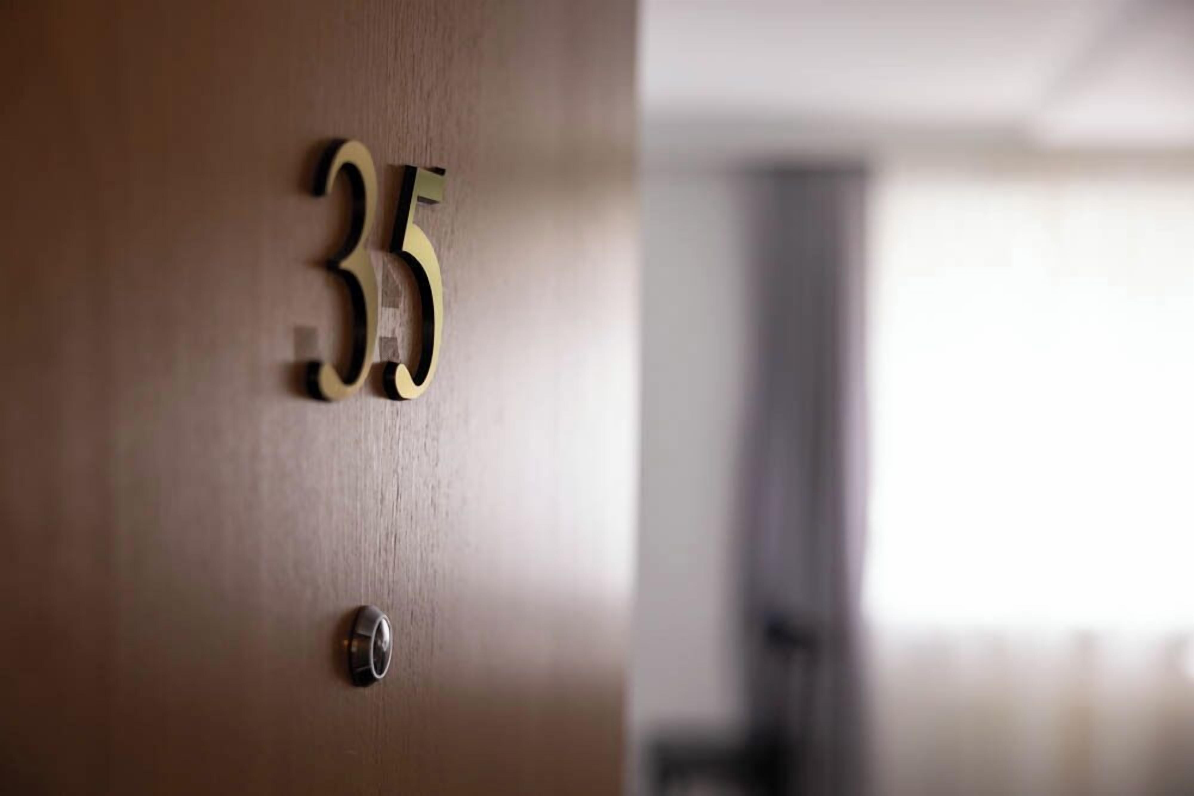 A close-up of a wooden door with the number 35 on it.
