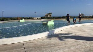 Ein Schwimmbecken mit freiem Blick auf das Meer im Hintergrund.