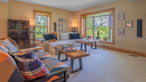 A spacious living room with a sofa, coffee table, and a glass door leading to a patio.