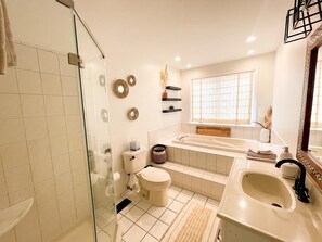 A modern bathroom with a glass shower enclosure, a freestanding bathtub, and a large vanity sink. - Bayview Sands - Modern, Pet Friendly, 6 BR/3BA on the Water! (Lower Township)