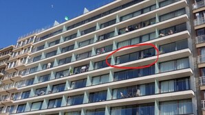 A multi-story hotel with balconies, a clear blue sky, and a red circle highlighting a specific window. - Apartment in Blankenberge With Sea View (Blankenberge)