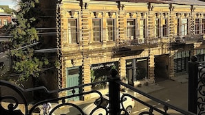 Ein historisches Gebäude mit einem Balkon und schmiedeeisernem Geländer.
