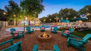 A backyard with a fire pit, lounge chairs, and a pool area. - The Ultimate Getaway: Pool, Pickleball, Mini Golf (San Antonio)