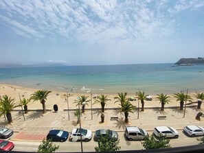 A beach view with parked cars and palm trees. - A step away from the beach, first line, incredible views brand new! (Puerto de Mazarrón)
