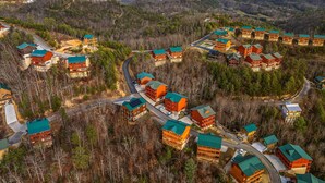 A resort with multiple buildings, roads, and forested hills. - Pvt Indoor Pool, Gorgeous 6-BR Cabin, Theater, BBQ (Sevierville)
