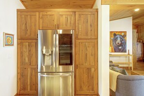 A stainless steel refrigerator in a kitchen with wooden cabinetry. - Short Drive to Itasca State Park - Waterfront Home (Park Rapids)