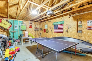 A room with a ping pong table, bicycles, and various sports equipment. - Short Drive to Itasca State Park - Waterfront Home (Park Rapids)