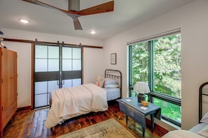 A bedroom with a bed, a desk, a window, and a ceiling fan. - Short Drive to Itasca State Park - Waterfront Home (Park Rapids)