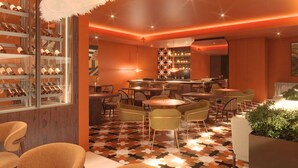 A modern bar area with a wine rack, multiple tables, and chairs. - Kimpton Atlantico Algarve (Albufeira)