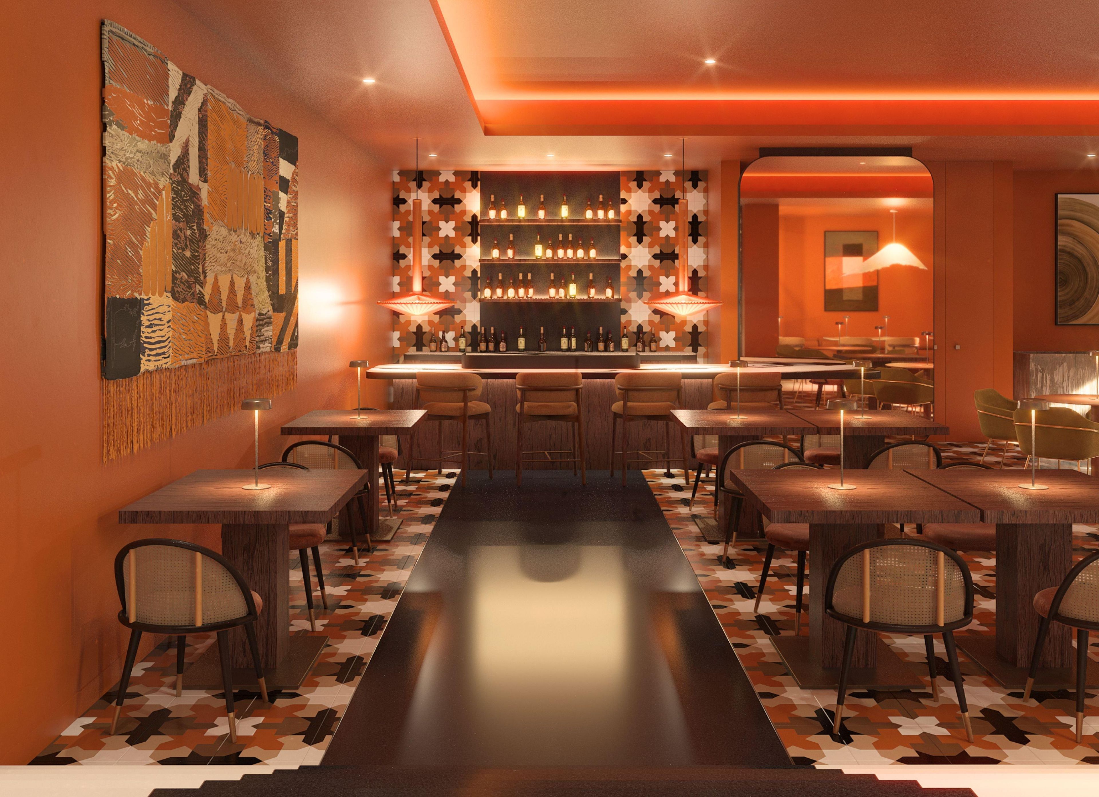 Een bar met een lange toonbank, meerdere krukken en een behang met patroon.