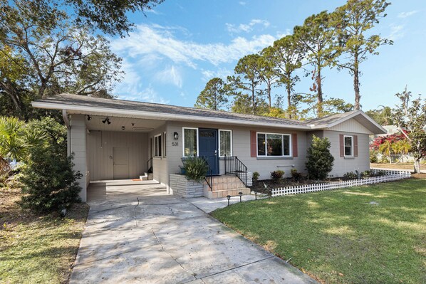 A single-story house with a front porch, a small front yard, and a mailbox.