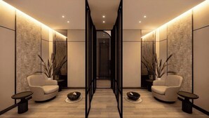 A modern hallway with two sofas, small tables, and decorative plants. - Mercure Madiun (Madiun)