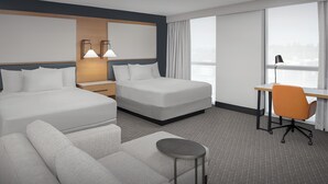 A modern hotel room with two beds, a desk, an orange chair, and a small round table. - Residence Inn by Marriott Seattle Northgate Station (Seattle)
