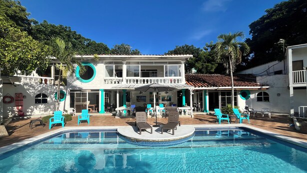A two-story building with a swimming pool in front. - Coral house San Andres (San Andrés)