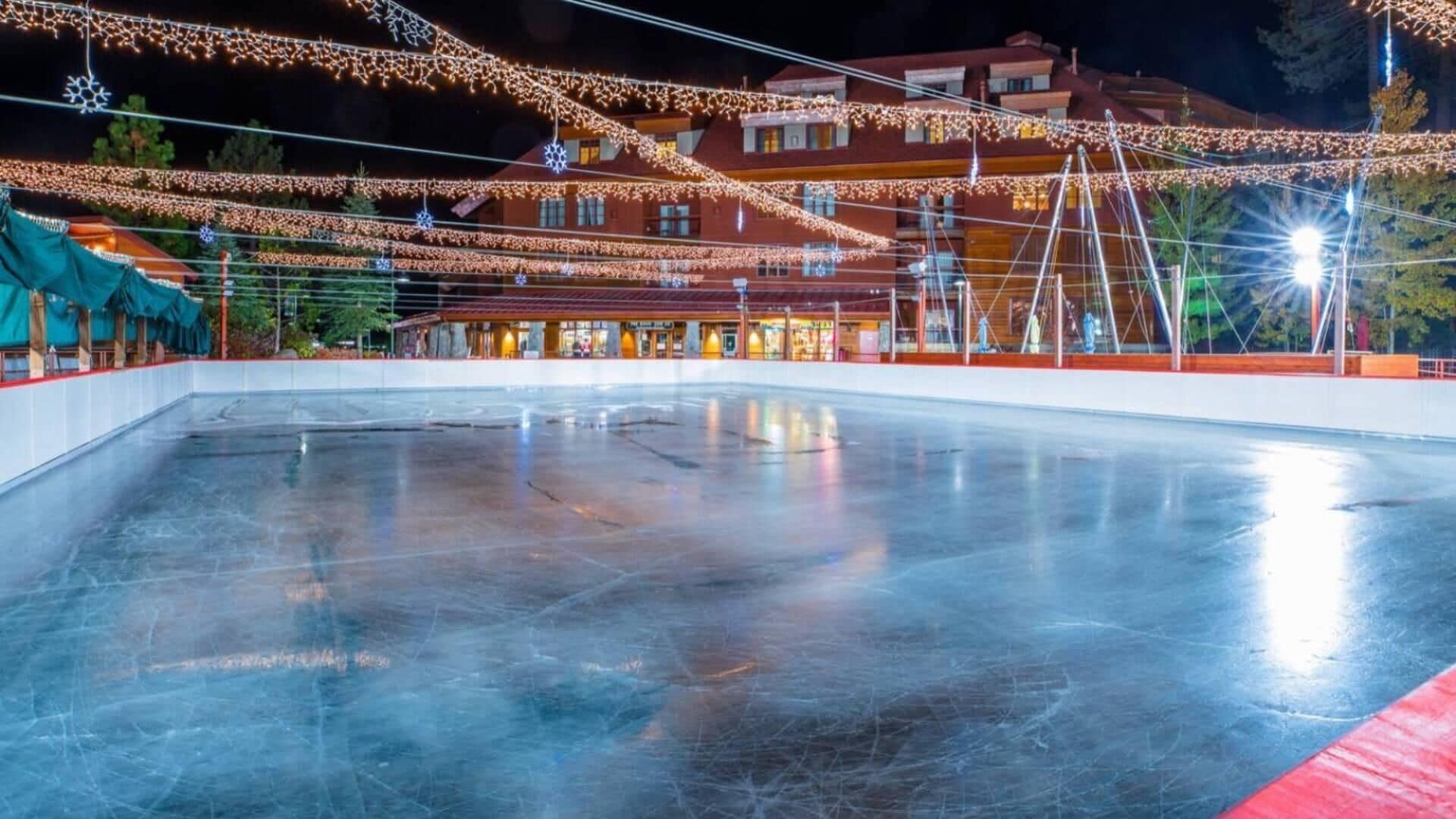 An ice skating rink with a building in the background.