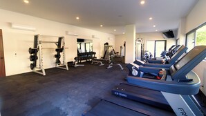 A gym with treadmills, weight machines, and free weights. - Oasis of Beauty (Puerto Vallarta)