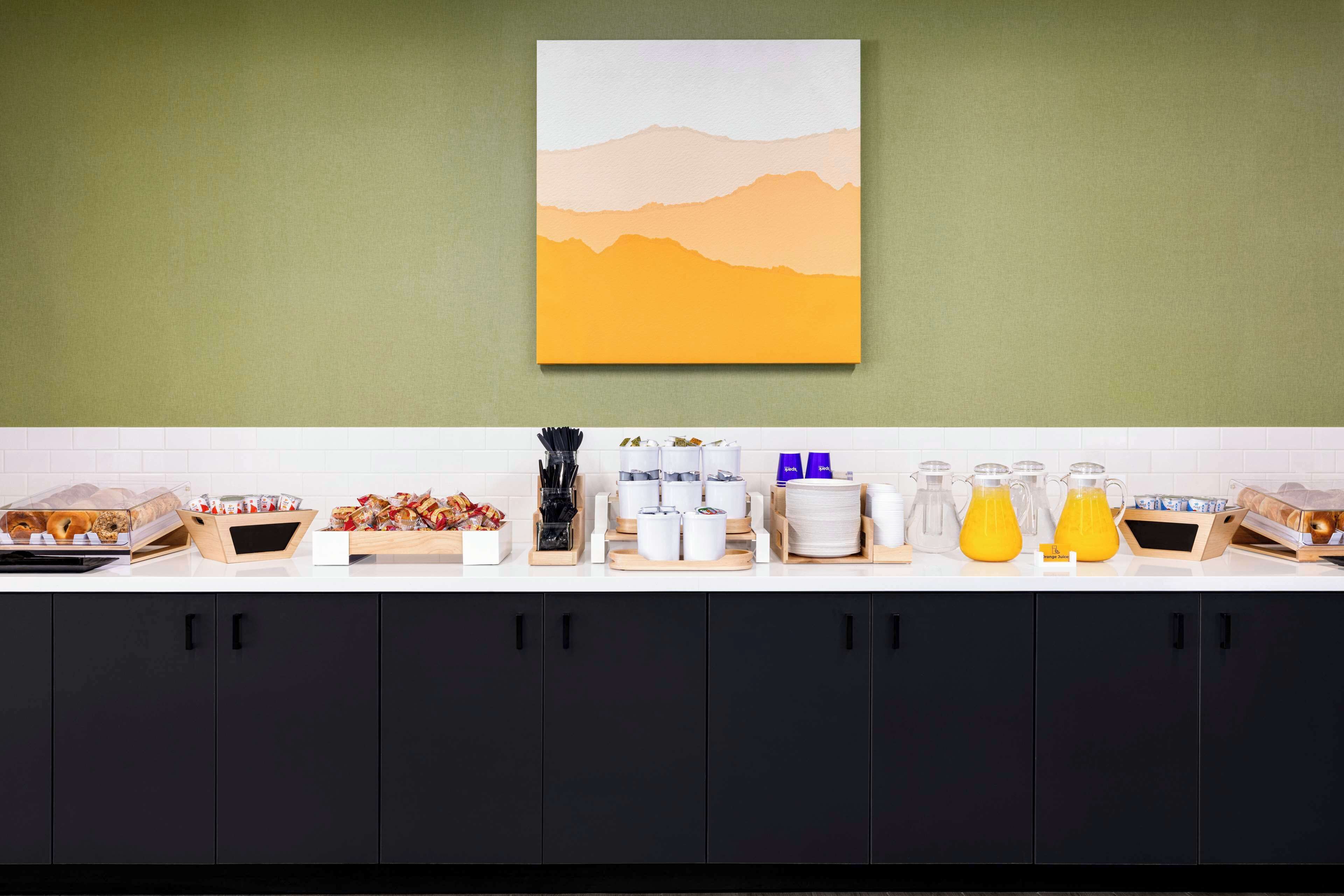 A kitchen counter with breakfast items, a coffee maker, and a fruit bowl.
