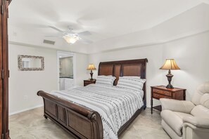 Relax in this inviting bedroom with a large bed, bedside tables, and a comfortable armchair.