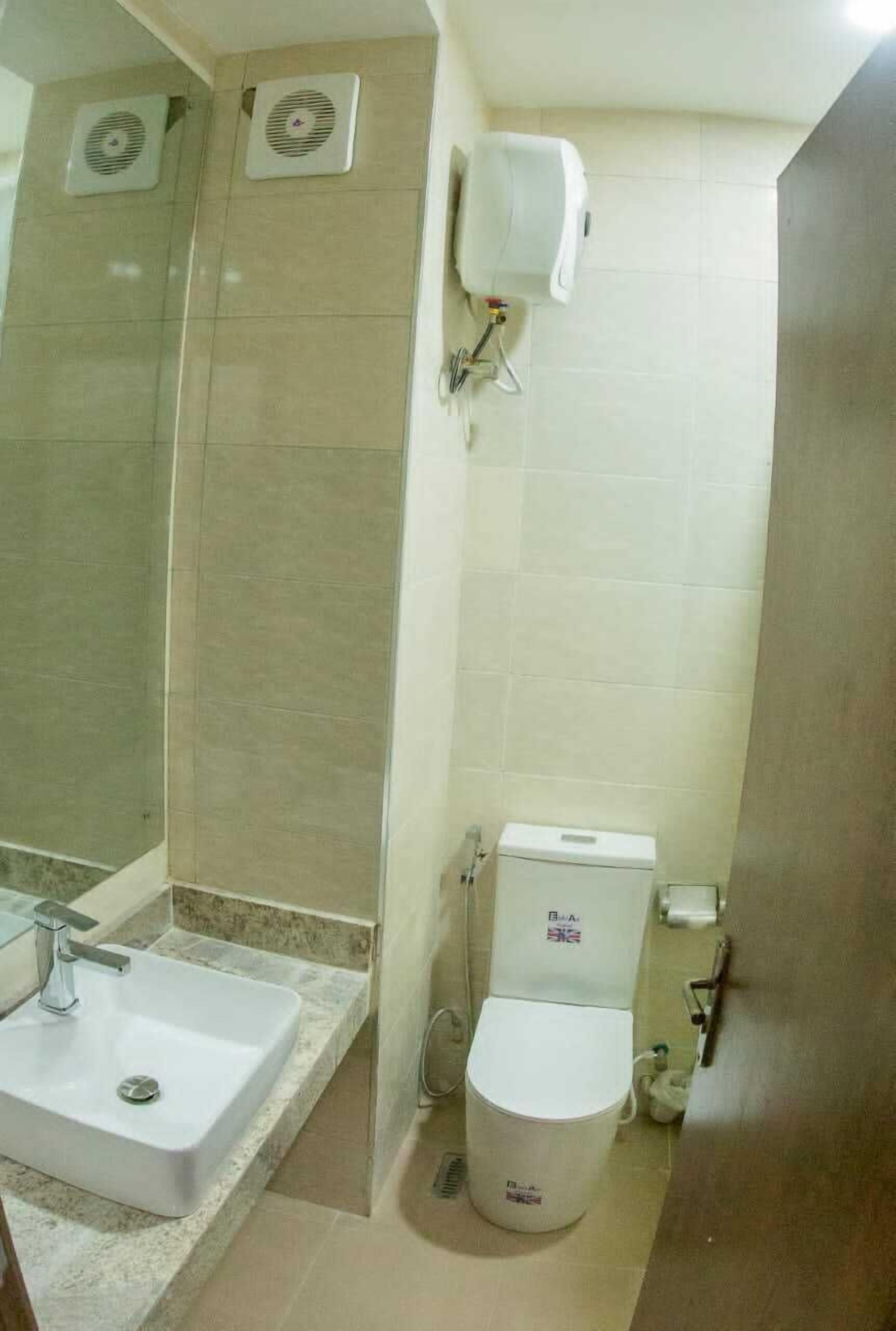 A bathroom with a sink, toilet, and shower.