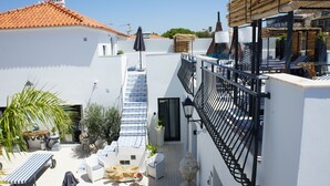A rooftop terrace with outdoor seating, a staircase, and a view of the city. - Walking distance to several beaches, Ferragudo village, supermarkets and Portimão,  (Ferragudo)