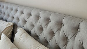 A room with a tufted headboard, framed artwork on the wall, and a neutral color scheme. - Walking distance to several beaches, Ferragudo village, supermarkets and Portimão,  (Ferragudo)