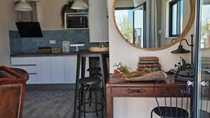 A modern kitchen with a central island, pendant lighting, and a large mirror. - Walking distance to several beaches, Ferragudo village, supermarkets and Portimão,  (Ferragudo)