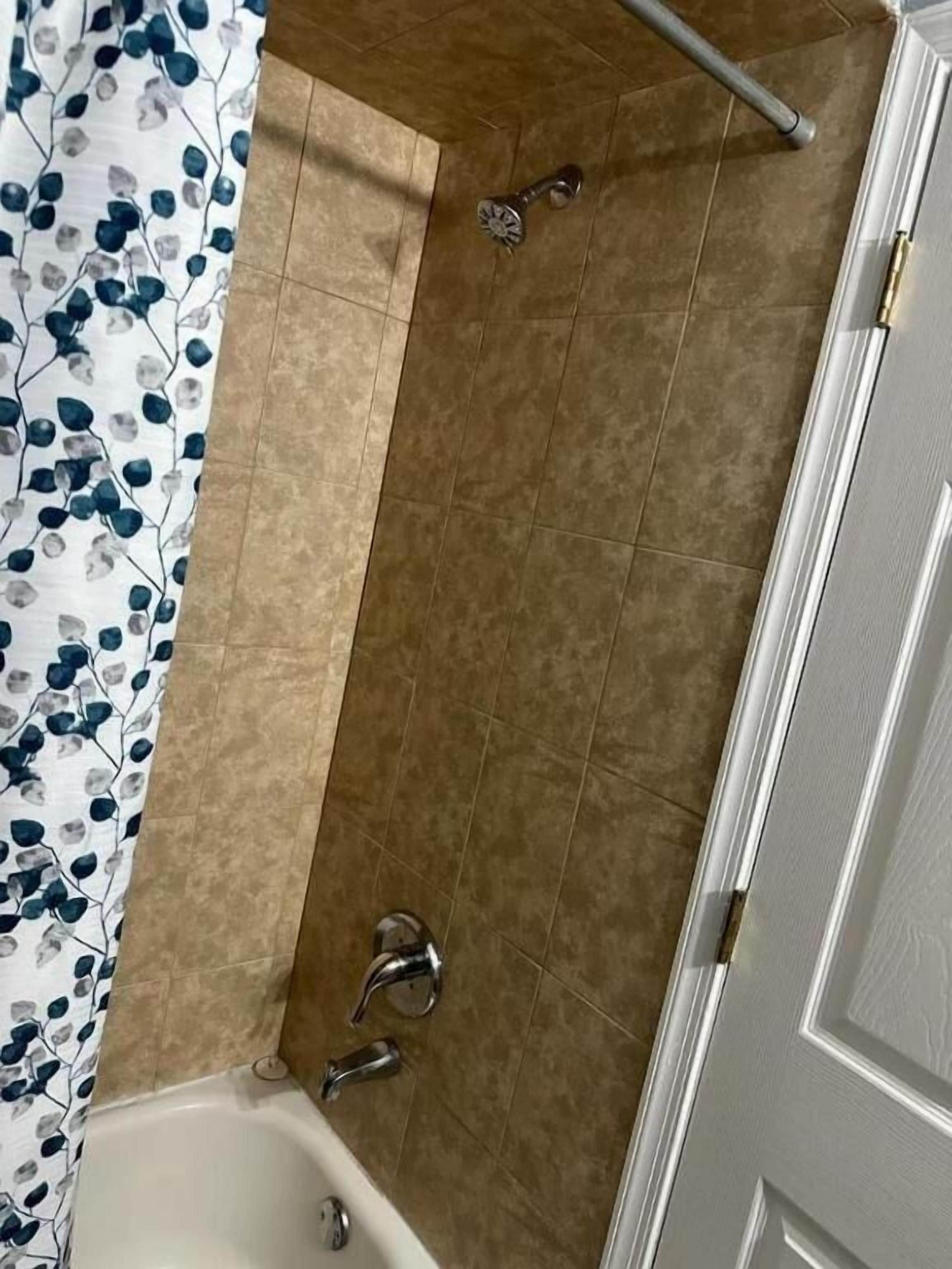 A bathroom with a bathtub, a shower, and a toilet.