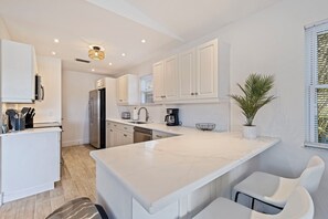 Fridge, microwave, oven, stovetop - Siesta Palms on 12th—Coastal Hideaway w/ Balcony, Beach Gear, & Walkable Access to Sand & Shops (Indian Rocks Beach)